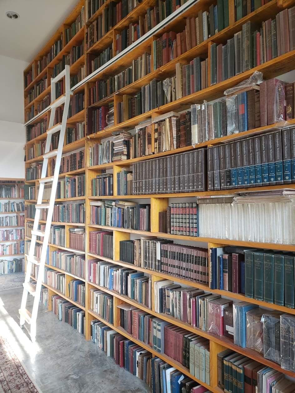 Floor-to-ceiling library bookshelves at Tree Roots Retreat