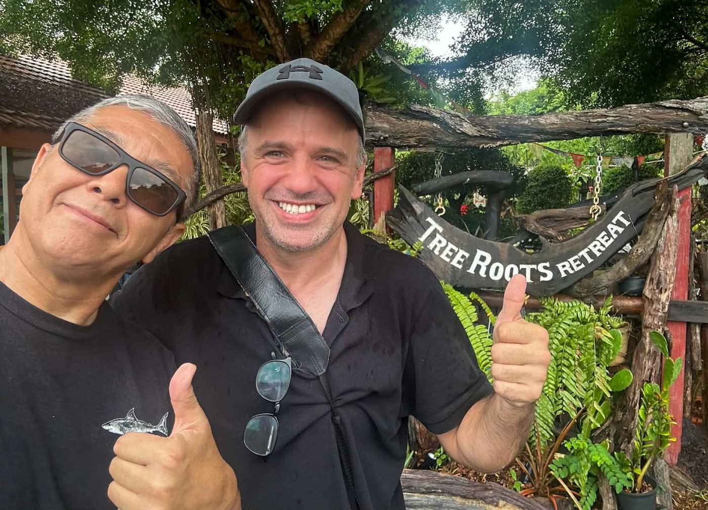 Michael and the host under the Tree Roots Retreat sign, a farewell after a week of training.